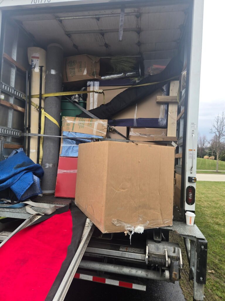 Professional movers organizing items safely inside the truck