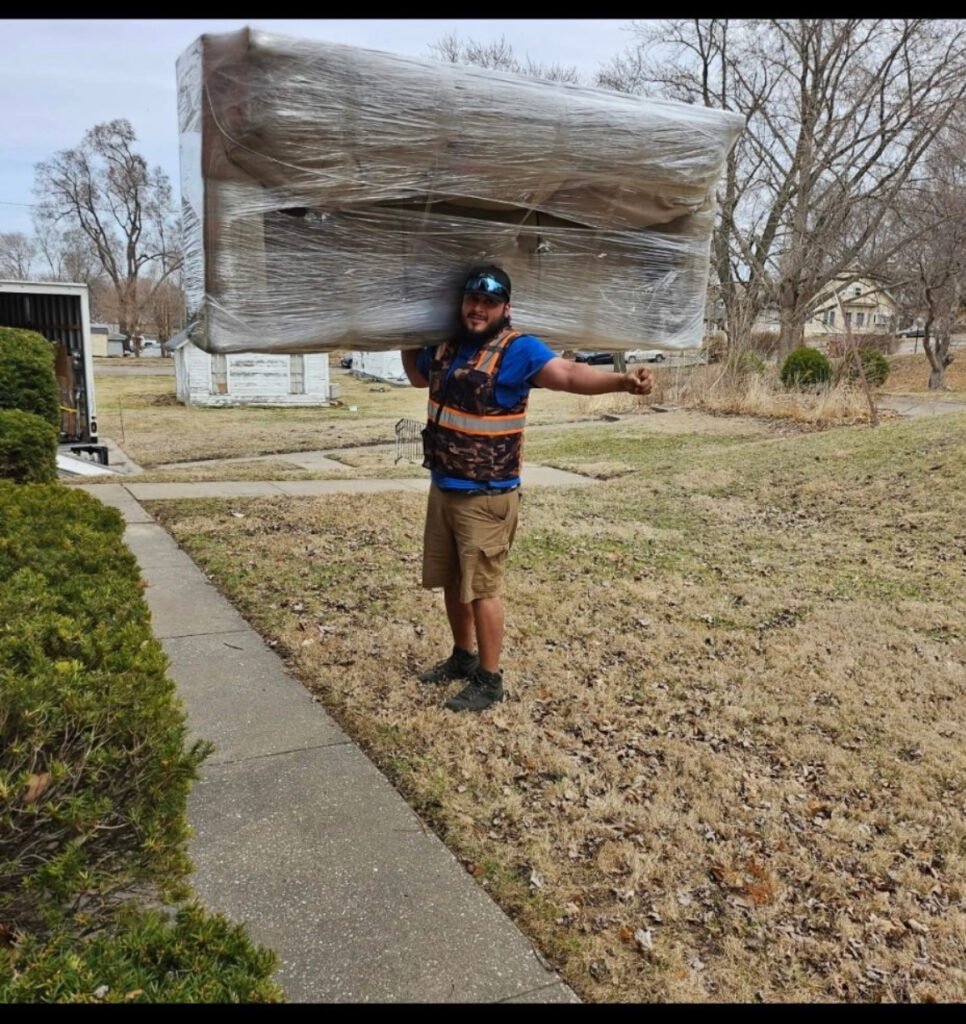 Professional movers protecting furniture