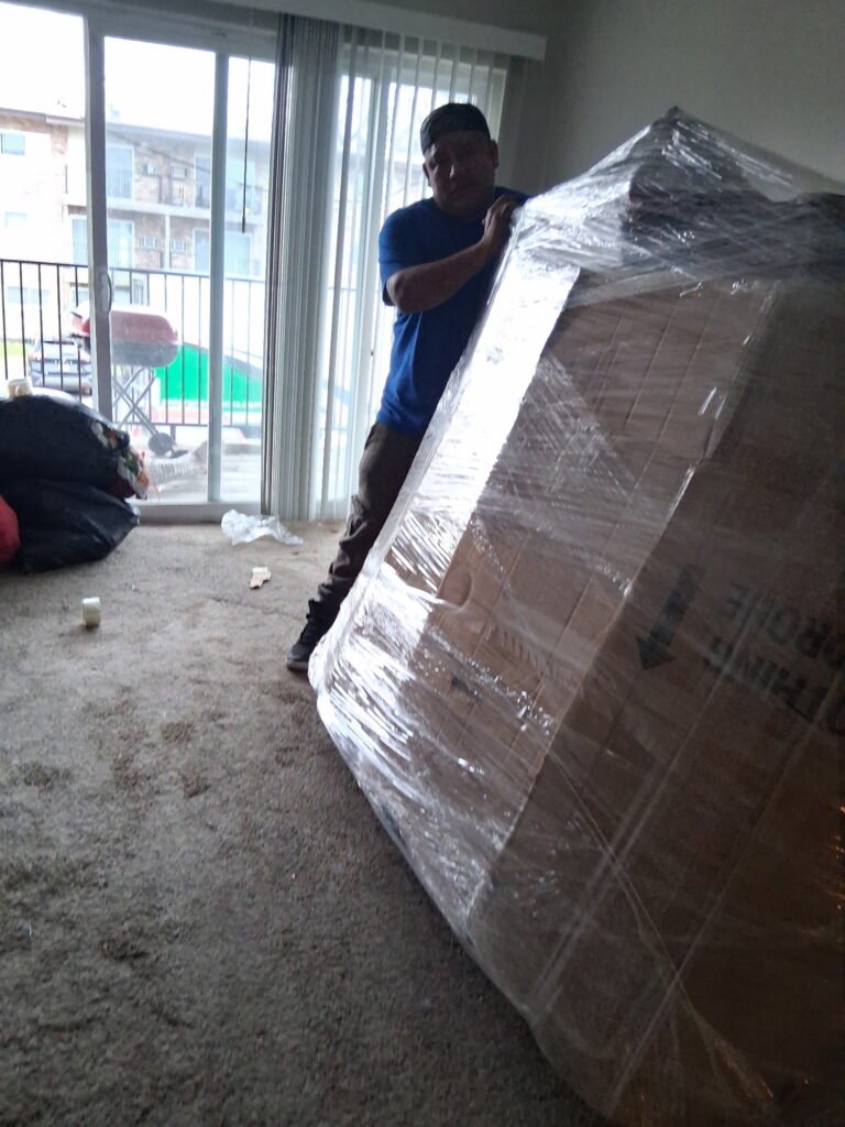 Professional Chicago movers wrapping furniture
